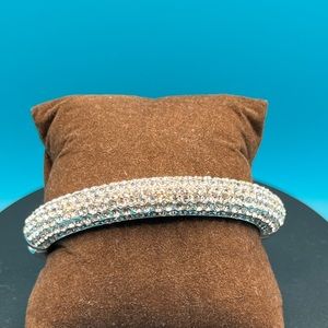 Preowned rhodium stainless steel hinged bracelet with pave’ crystals.